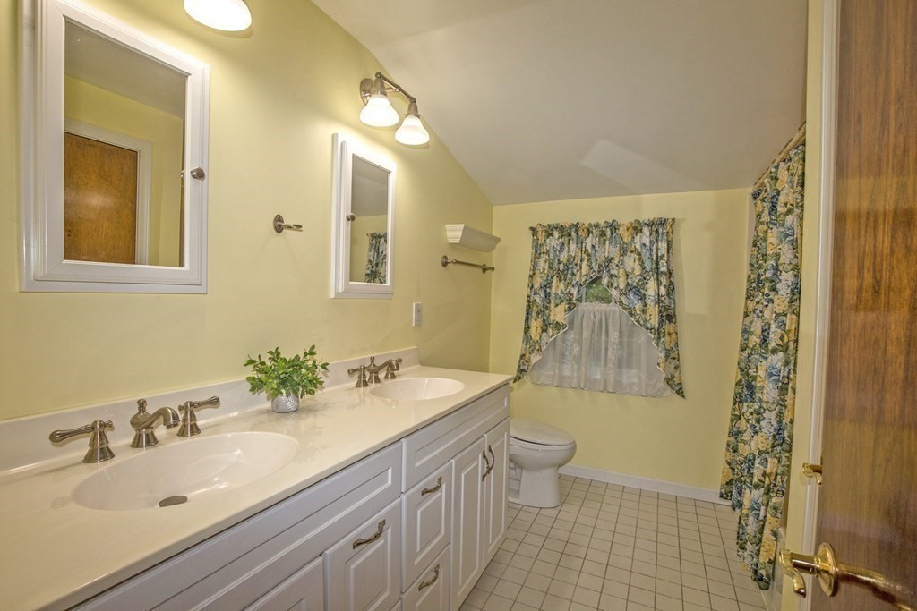477 Wolf Swamp Road Longmeadow, MA 01106 - Photo 28 of 35 a bathroom with a double vanity sink toilet and shower