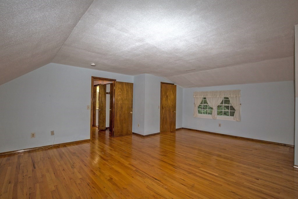 477 Wolf Swamp Road Longmeadow, MA 01106 - Photo 29 of 35 an empty room with wooden floor and windows