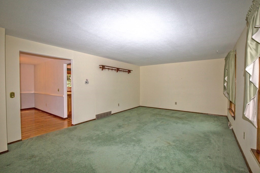 477 Wolf Swamp Road Longmeadow, MA 01106 - Photo 10 of 35 an empty room with wooden floor and entrance