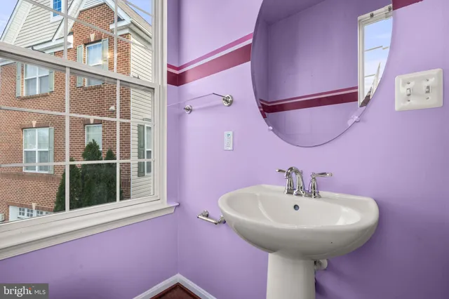 a bathroom with a sink a mirror and a window