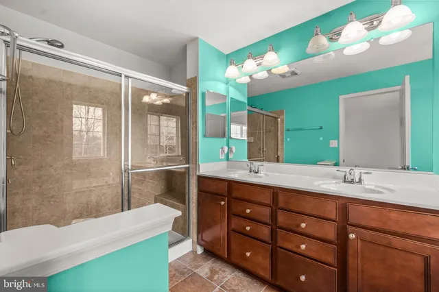 a bathroom with a sink vanity granite and a mirror