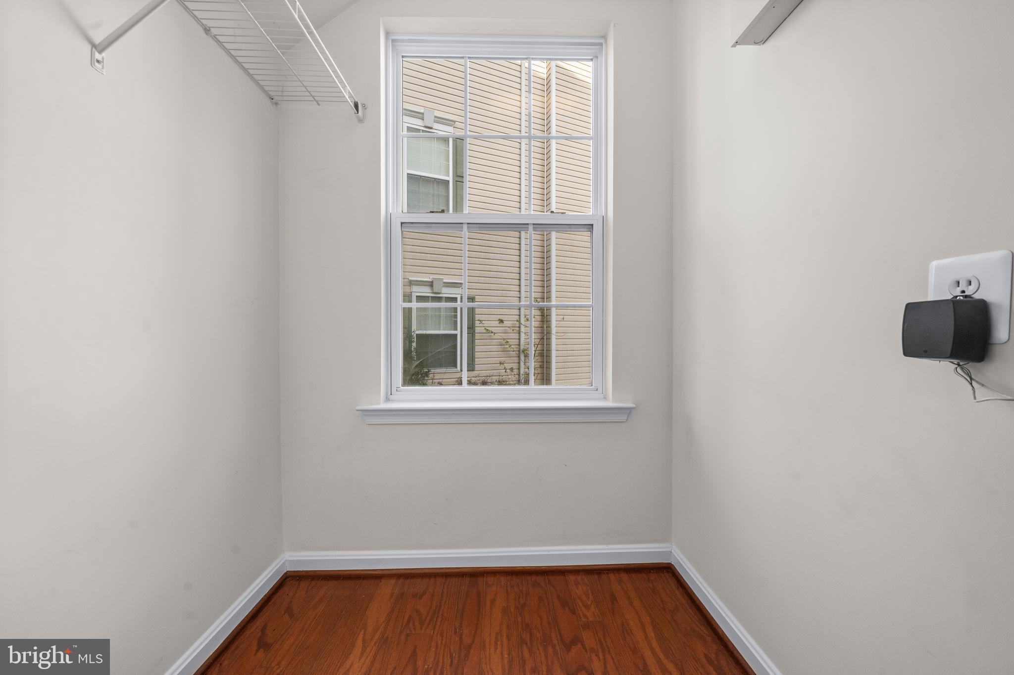 109 Gray Street Capitol Heights, MD 20743 - Photo 25 of 35 a view of an empty room with a window and wooden floor