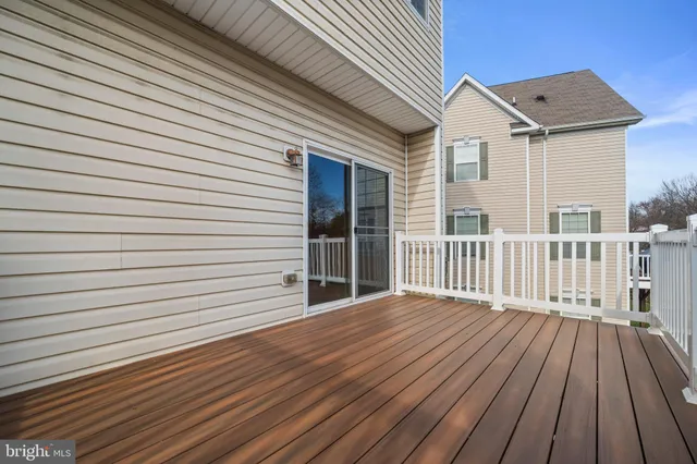 a view of backyard with a wooden deck