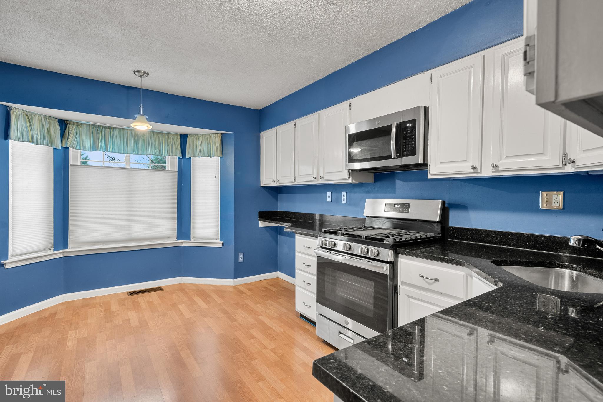 5 Lantern Lane Chesterbrook, PA 19087 - Photo 12 of 30 a kitchen with stainless steel appliances granite countertop a stove a sink and a microwave
