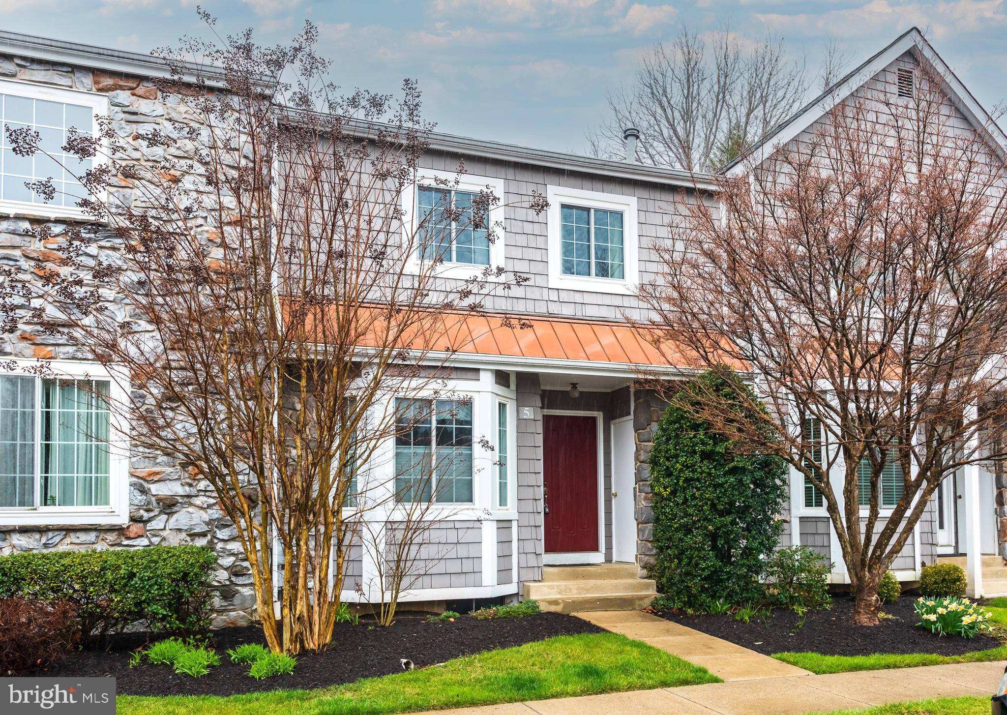 5 Lantern Lane Chesterbrook, PA 19087 - Photo 2 of 30 a front view of a house with a garden and trees