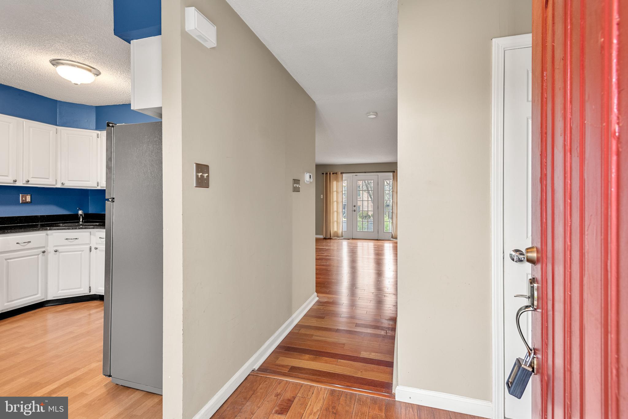 5 Lantern Lane Chesterbrook, PA 19087 - Photo 3 of 30 a view of a hallway with wooden floor and staircase