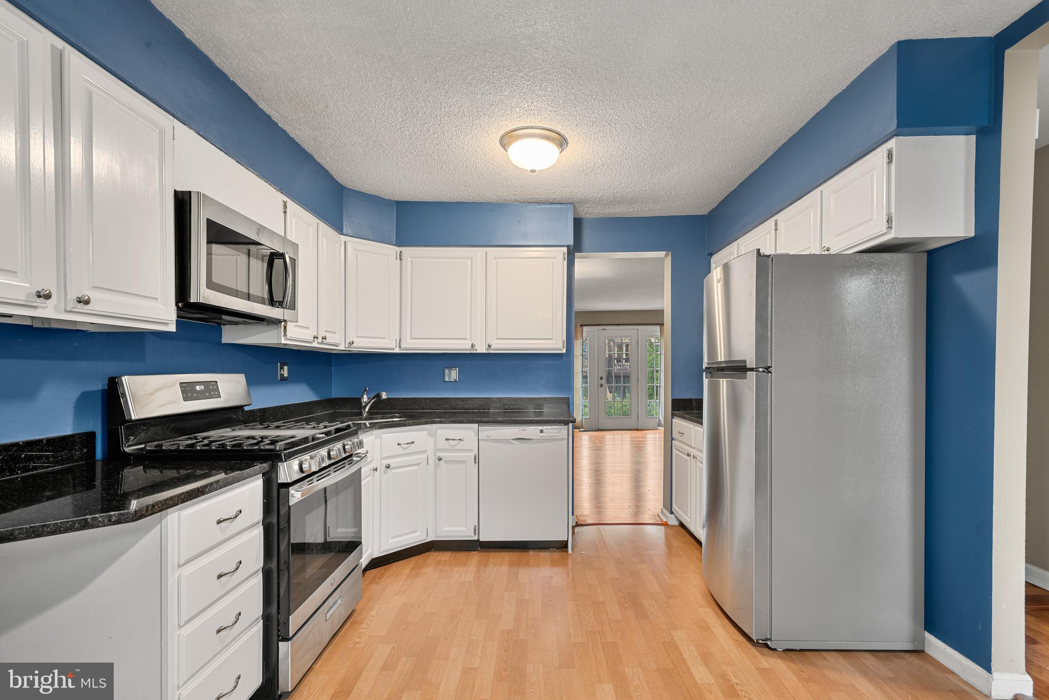 5 Lantern Lane Chesterbrook, PA 19087 - Photo 10 of 30 a kitchen with granite countertop white cabinets and refrigerator