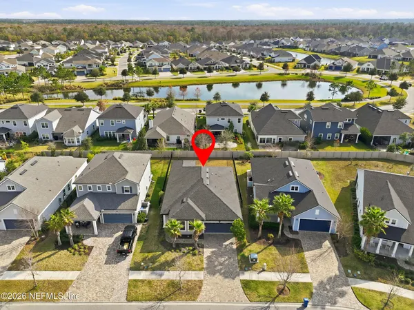 a front view of a house with yard and parking
