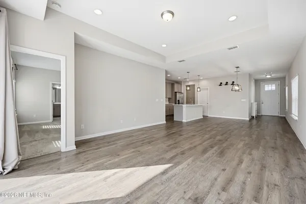 a kitchen with stainless steel appliances granite countertop a sink a window and wooden floor