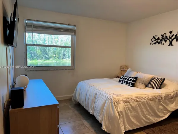 a bedroom with a bed and window