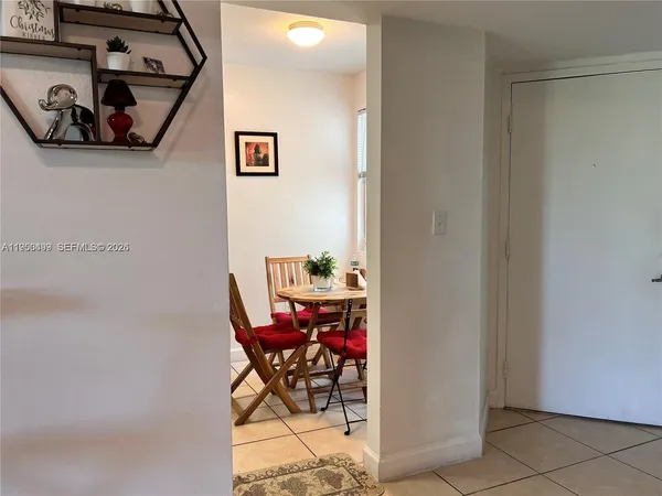 a view of a hallway with dining area view and living room view