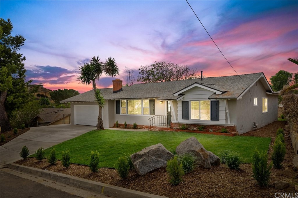 6666 Garces Avenue Riverside, CA 92509 - Photo 1 of 1 a front view of a house with a yard and garage