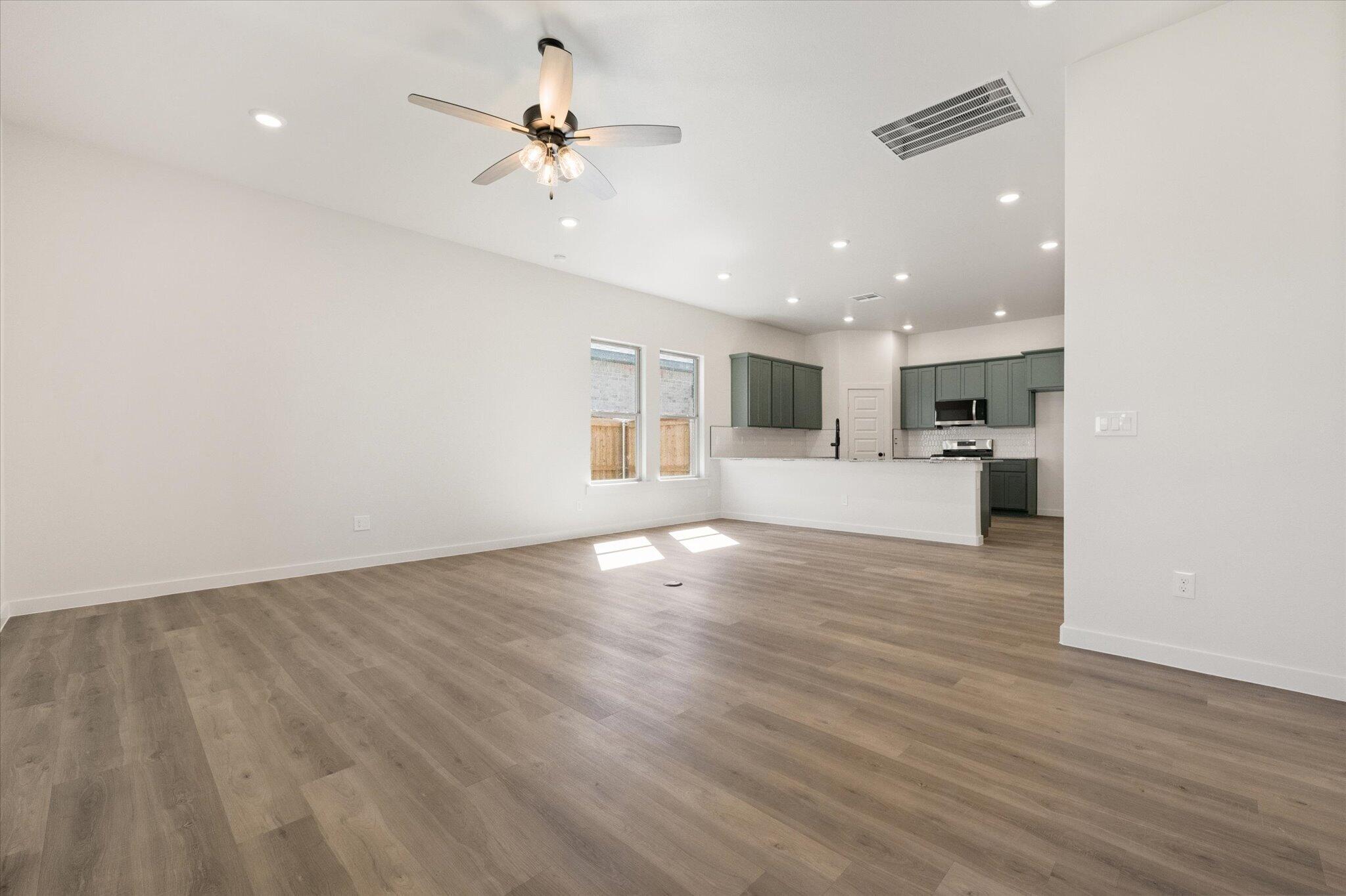 7003 53rd Street Lubbock, TX 79407 - Photo 6 of 25 a view of large kitchen with a sink a refrigerator and window