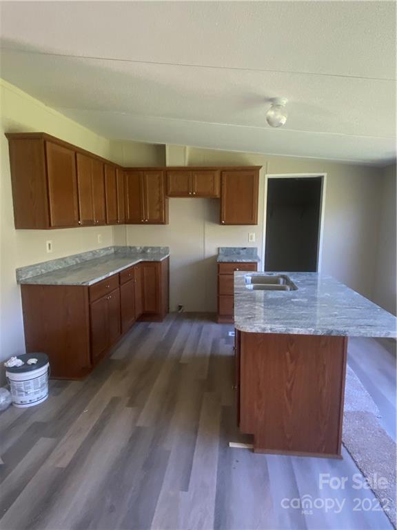149 Ayers Road Grover, NC 28073 - Photo 4 of 17 a kitchen with stainless steel appliances granite countertop wooden floors and wooden cabinets