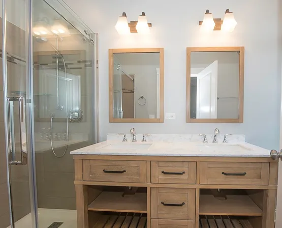 a bathroom with a double vanity sink mirror and