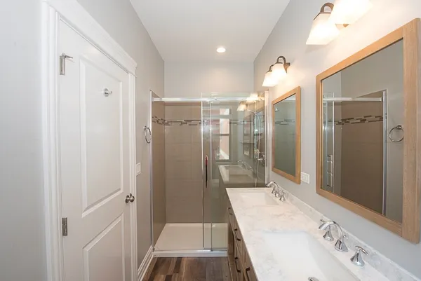 a bathroom with a sink a mirror and a shower
