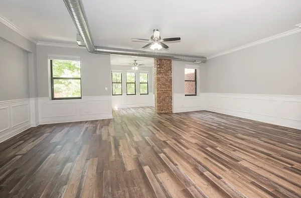 wooden floor in an empty room with a window