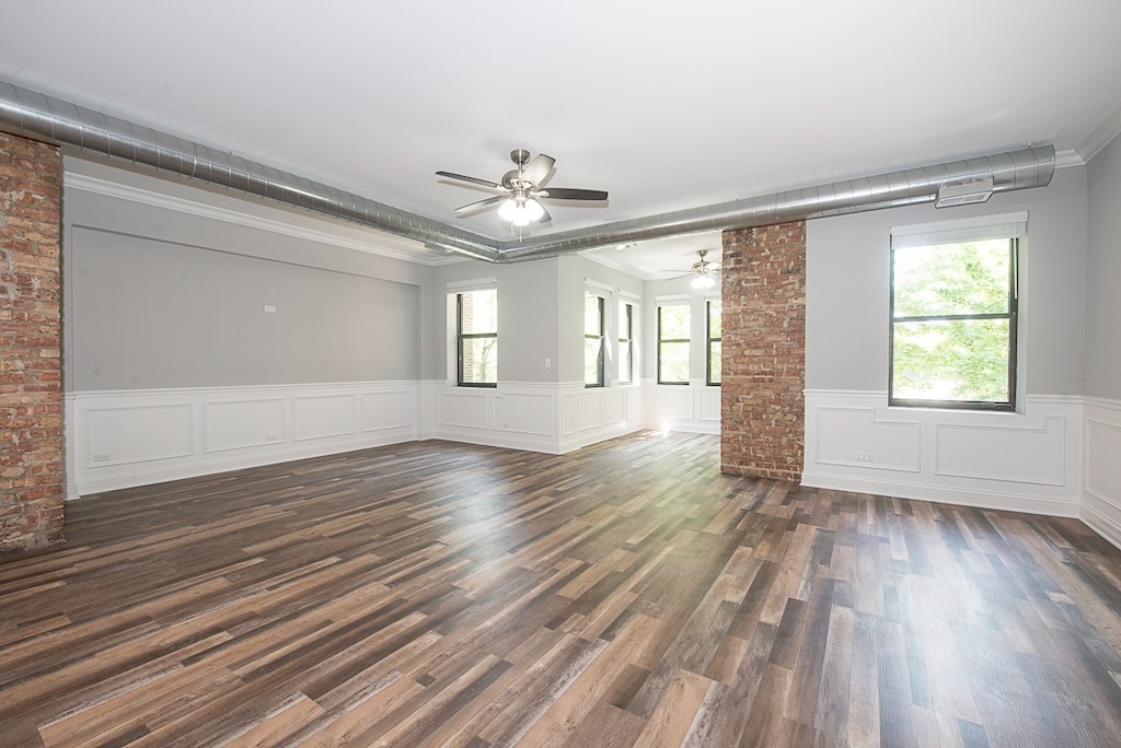 4117 South Michigan Avenue, Unit 2N Chicago, IL 60653 - Photo 8 of 20 a view of an empty room with wooden floor and a window