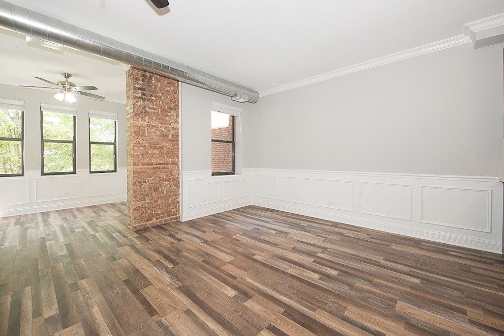 4117 South Michigan Avenue, Unit 2N Chicago, IL 60653 - Photo 9 of 20 a view of an empty room with wooden floor and a window