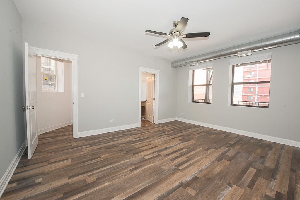 4117 South Michigan Avenue, Unit 2N Chicago, IL 60653 - Photo 10 of 20 a view of empty room with wooden floor and fan