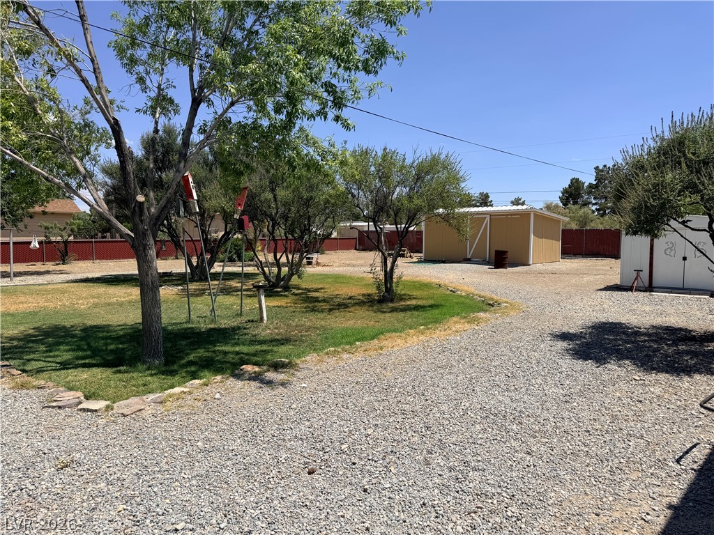 1391 West Dyer Road Pahrump, NV 89048 - Photo 26 of 50 A vast, private yard with mature trees and a fenced perimeter offers ample outdoor space.