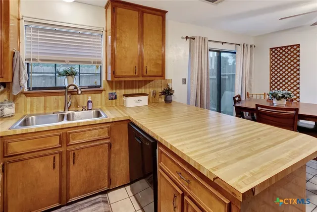 a kitchen with a stove a sink and a refrigerator