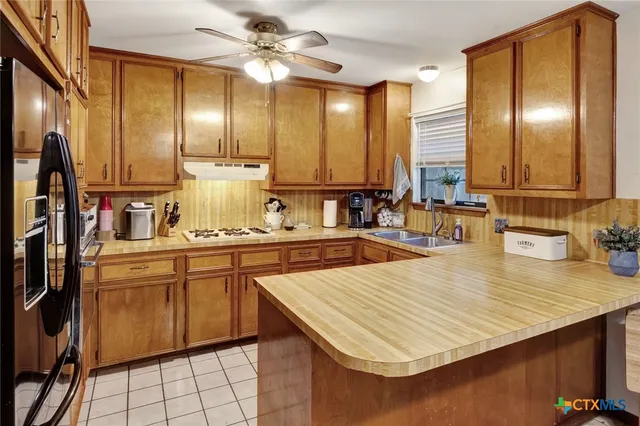 a kitchen with stainless steel appliances granite countertop a sink counter space and a window