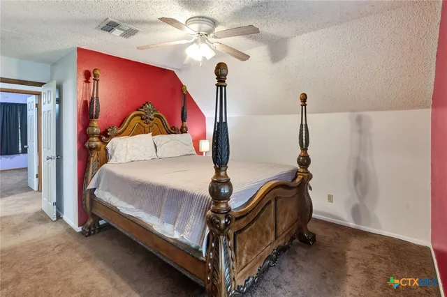 a bed room with a bed and a chandelier