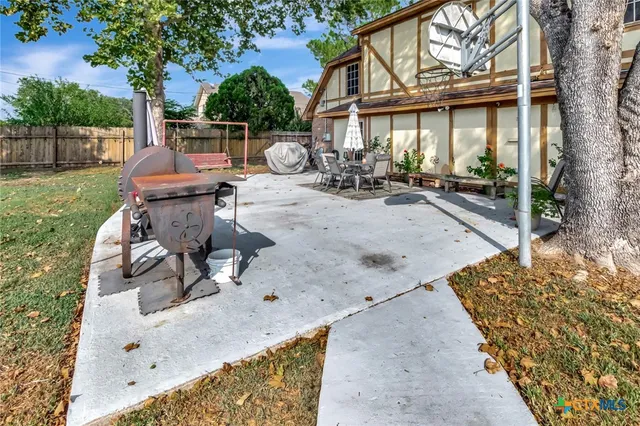 a view of backyard with outdoor seating and plants