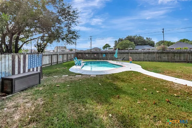 a swimming pool with wooden fence
