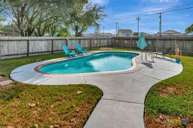 a view of a swimming pool with a yard