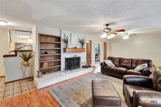 a living room with furniture and a fireplace