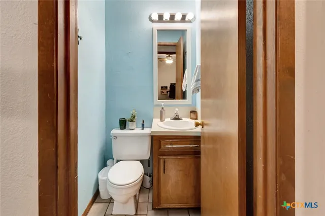 a bathroom with a toilet sink and mirror