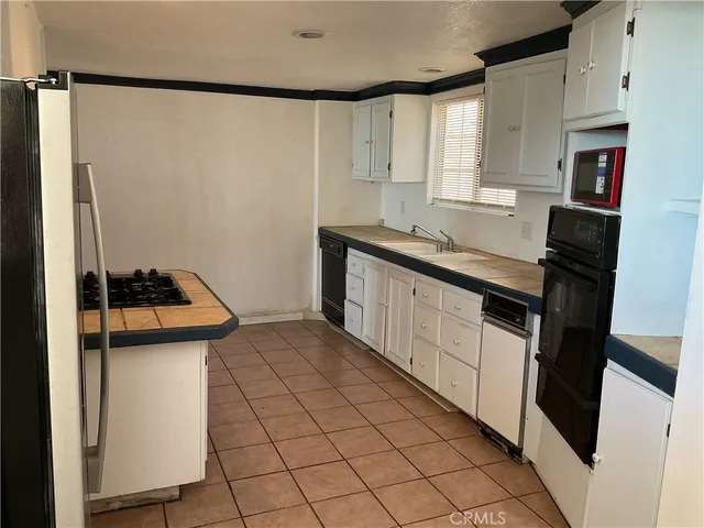 a kitchen with stainless steel appliances a refrigerator sink and stove