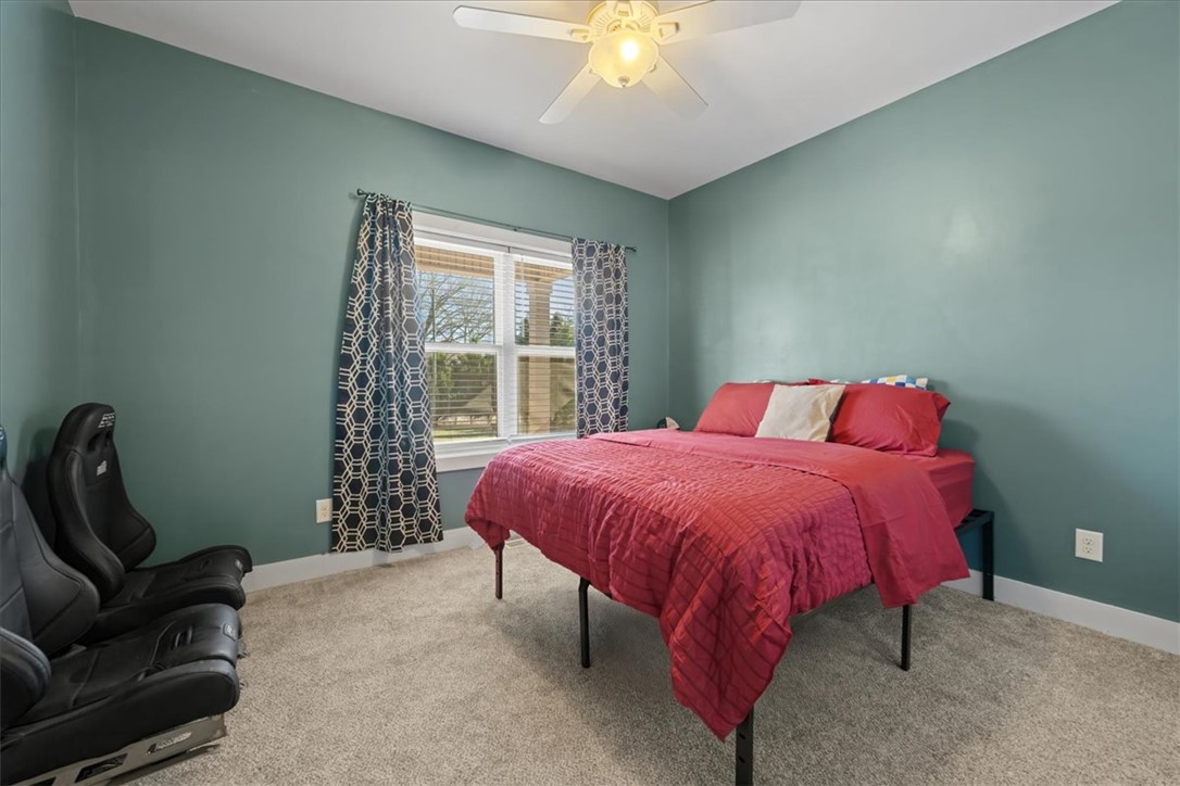 212 Winding Lane Seneca, SC 29672 - Photo 19 of 47 This cozy bedroom offers a tranquil retreat with soft lighting and ample space for relaxation.