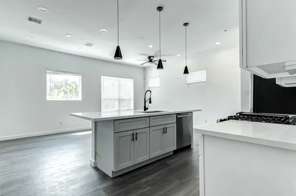 a kitchen with a sink a window and stainless steel appliances