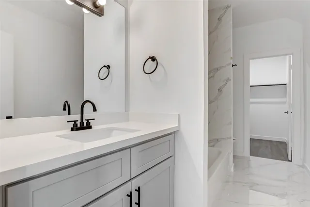 a bathroom with a bathtub and shower