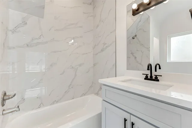 a bathroom with a sink a bathtub and a shower