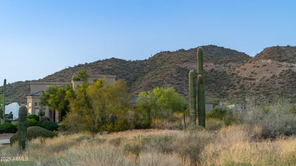 a view of a house with a mountain and a forest