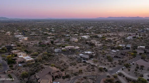 an aerial view of residential houses with city view