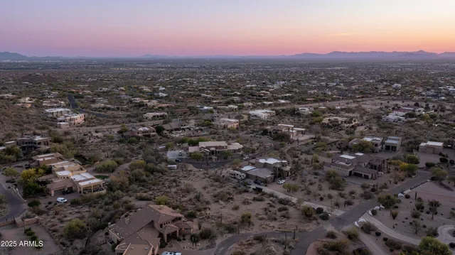 an aerial view of residential houses with city view