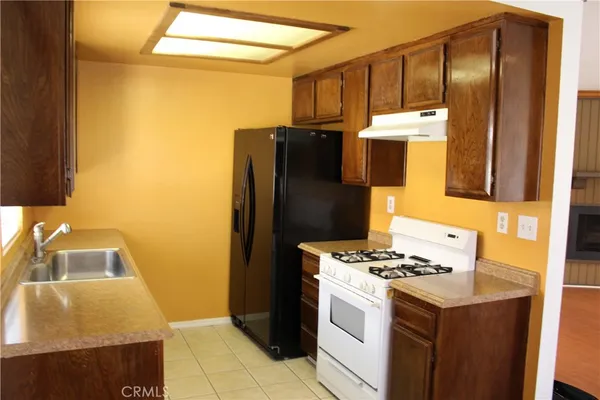 a kitchen with a sink and a refrigerator