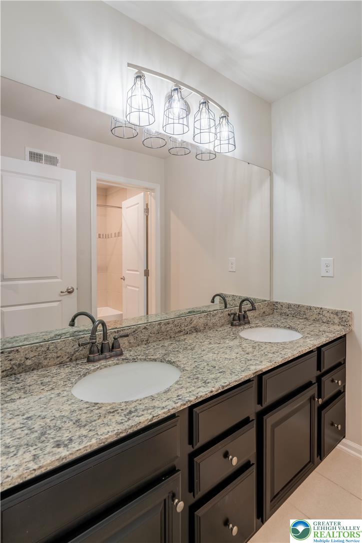 4758 Rafi Road Easton, PA 18045 - Photo 27 of 55 Double vanities with granite counters provide ample space and sophisticated utility in this well-appointed bathroom.