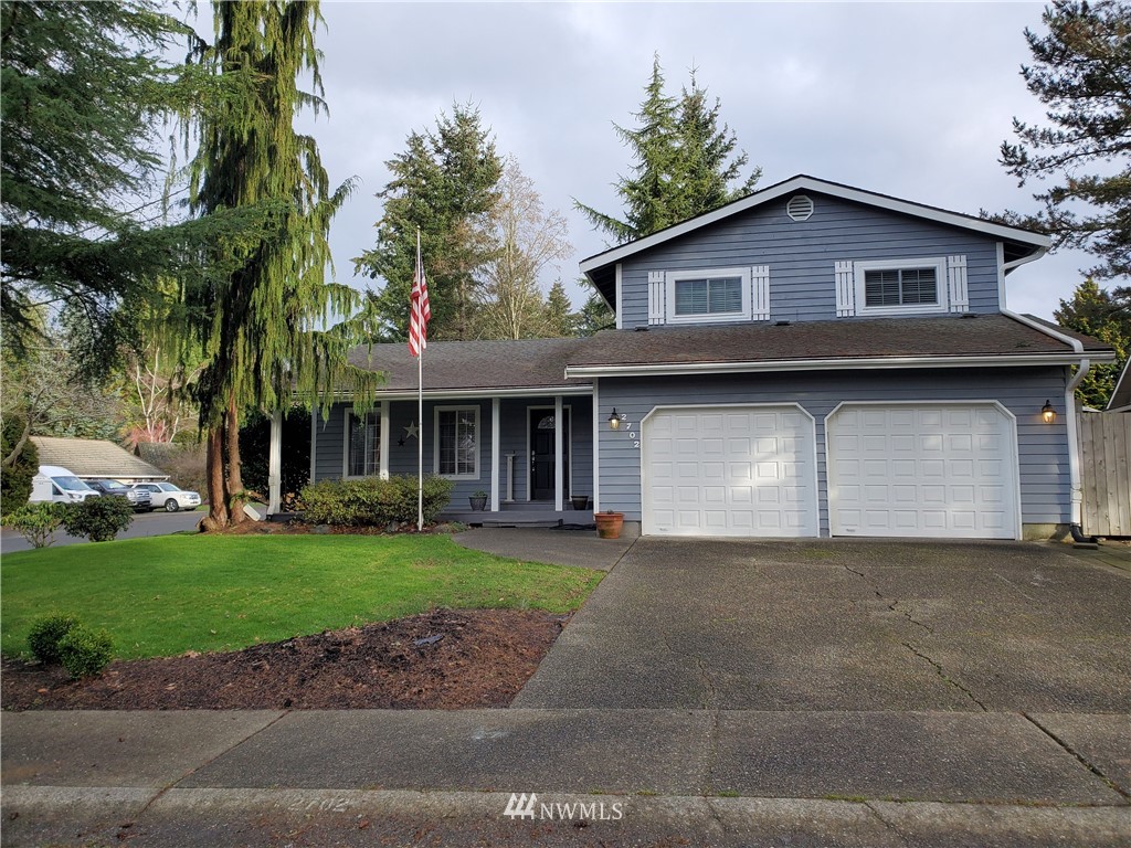 2702 Allen Road Southeast Olympia, WA 98501 - Photo 2 of 37 a front view of a house with a yard and garage