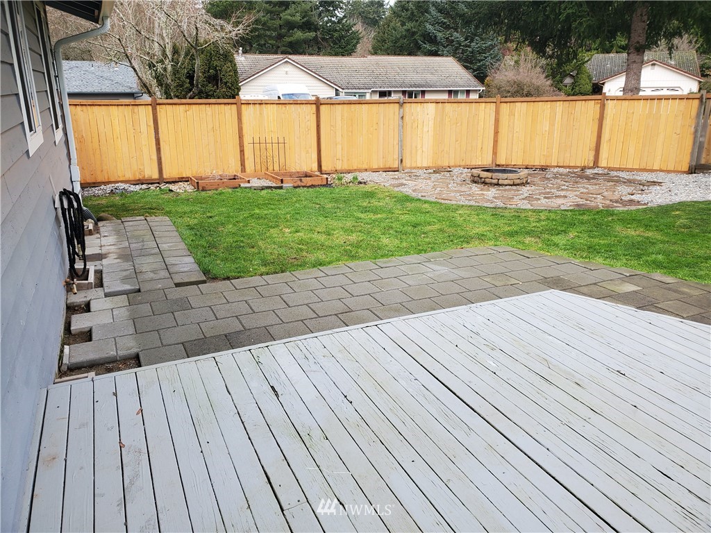 2702 Allen Road Southeast Olympia, WA 98501 - Photo 28 of 37 a view of a backyard with table and chairs under an umbrella