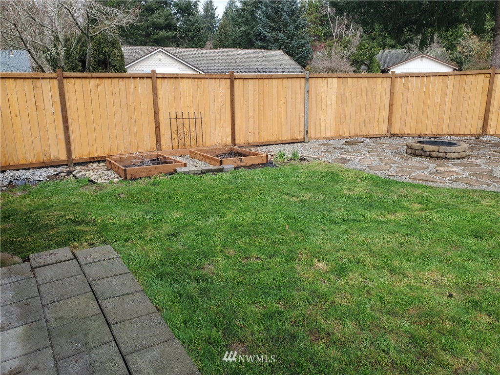2702 Allen Road Southeast Olympia, WA 98501 - Photo 33 of 37 a view of a backyard with table and chairs under an umbrella