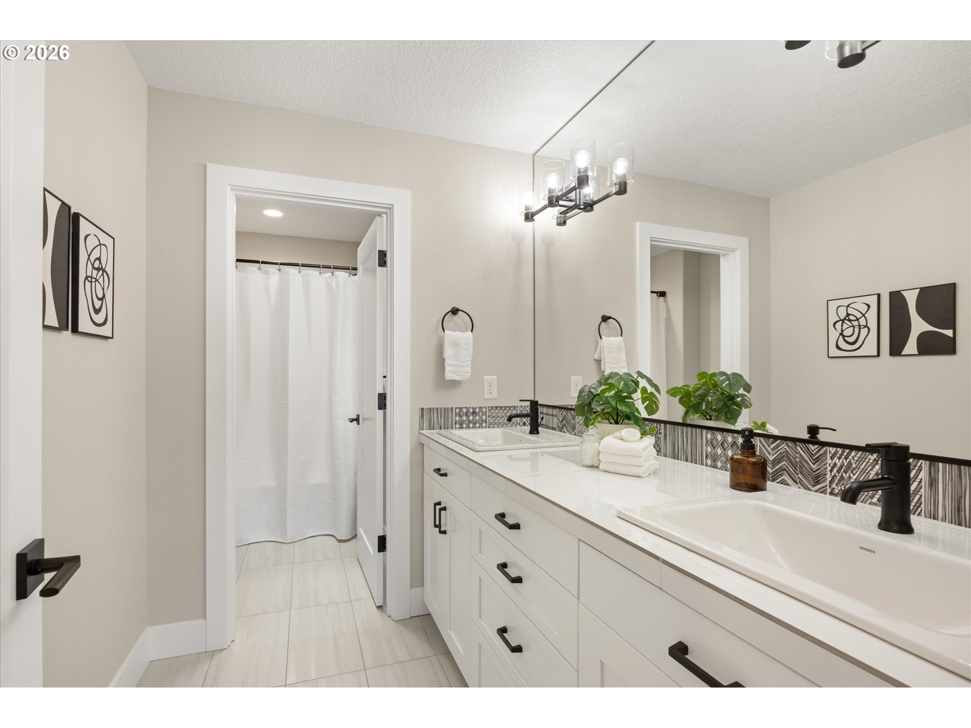 14551 Southwest 153rd Avenue Portland, OR 97224 - Photo 32 of 45 a bathroom with a double vanity sink a mirror a and a shower