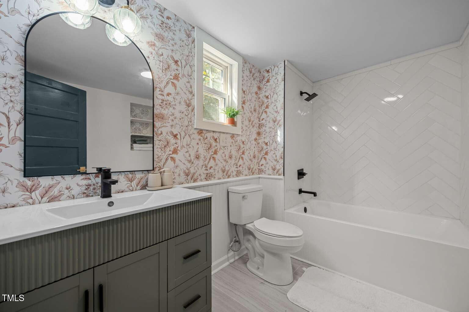 523 East Main Street Haw River, NC 27258 - Photo 11 of 25 a bathroom with a sink a toilet and a mirror