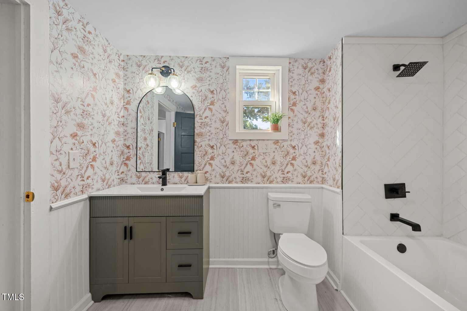 523 East Main Street Haw River, NC 27258 - Photo 12 of 25 a bathroom with a sink a toilet and shower