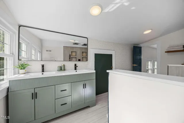 a spacious bathroom with a granite countertop sink mirror and toilet